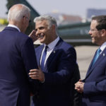
              U.S. President Joe Biden shakes hands with Israel's Prime Minister Yair Lapid before his departure to Saudi Arabia from Ben Gurion airport near Tel Aviv, Israel Friday, July 15, 2022. On the right is Israel's President Isaac Herzog. (AP Photo/Evan Vucci)
            