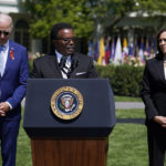 
              President Joe Biden and Vice President Kamala Harris listen as Garnell Whitfield Jr., who lost his mother Ruth Whitfield in the Tops market mass shooting in Buffalo, speaks during an event to celebrate the passage of the "Bipartisan Safer Communities Act," on the South Lawn of the White House, Monday, July 11, 2022, in Washington. (AP Photo/Evan Vucci)
            