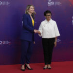 
              Indonesian Foreign Minister Retno Marsudi, right, greets Canadian Foreign Minister Melanie Joly upon arrival at the G20 Foreign Ministers' Meeting in Nusa Dua, Bali, Indonesia, Friday, July 8, 2022. (AP Photo/Dita Alangkara, Pool)
            