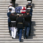 
              The flag-draped casket bearing the remains of Hershel W. "Woody" Williams is carried by joint service members into the U.S. Capitol, Thursday, July 14, 2022 in Washington, to lie in honor. Williams, the last remaining Medal of Honor recipient from World War II, died at age 98. (AP Photo/Jose Luis Magana)
            
