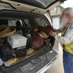 
              Paul Williams, Luthery Instructor at the Applachian School of Luthery loads instruments he hopes to save that were damaged in the floodwaters of Troublesome Creek into his truck in Hindman, Ky., Sunday, July 31, 2022. (AP Photo/Timothy D. Easley)
            