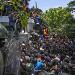 
              Protesters storm the Sri Lankan Prime Minister Ranil Wickremesinghe's office, demanding he resign after president Gotabaya Rajapaksa fled the country amid economic crisis in Colombo, Sri Lanka, Wednesday, July 13, 2022. Sri Lanka’s president fled the country without stepping down Wednesday, plunging a country already reeling from economic chaos into more political turmoil. Protesters demanding a change in leadership then trained their ire on the prime minister and stormed his office. (AP Photo/ Photo/Rafiq Maqbool)
            