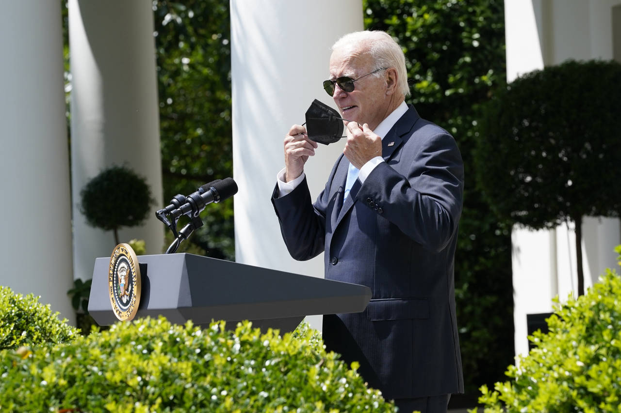 President Joe Biden takes off his mask as he starts to speak in the Rose Garden of the White House ...