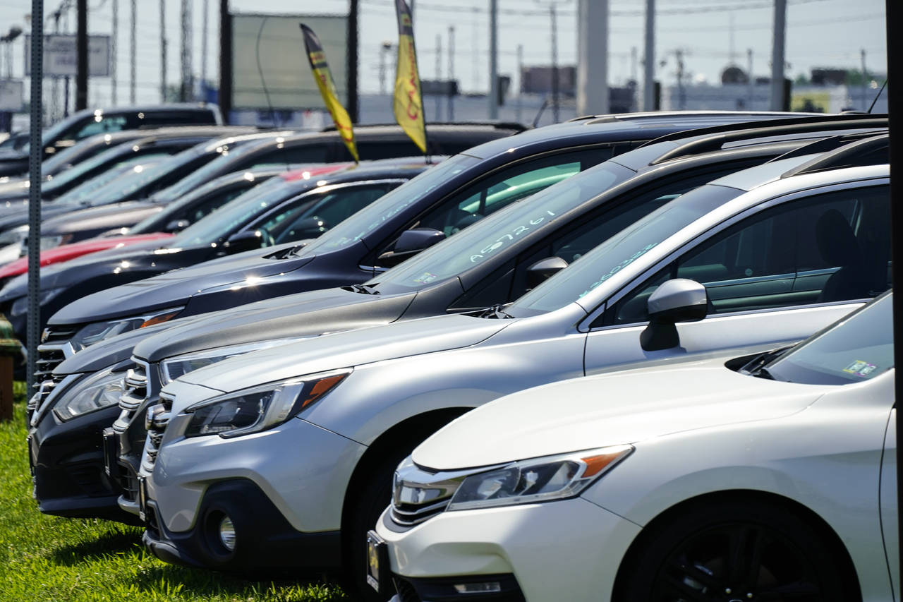 Used cars for sale are parked roadside at an auto lot in Philadelphia, Tuesday, July 12, 2022. On W...