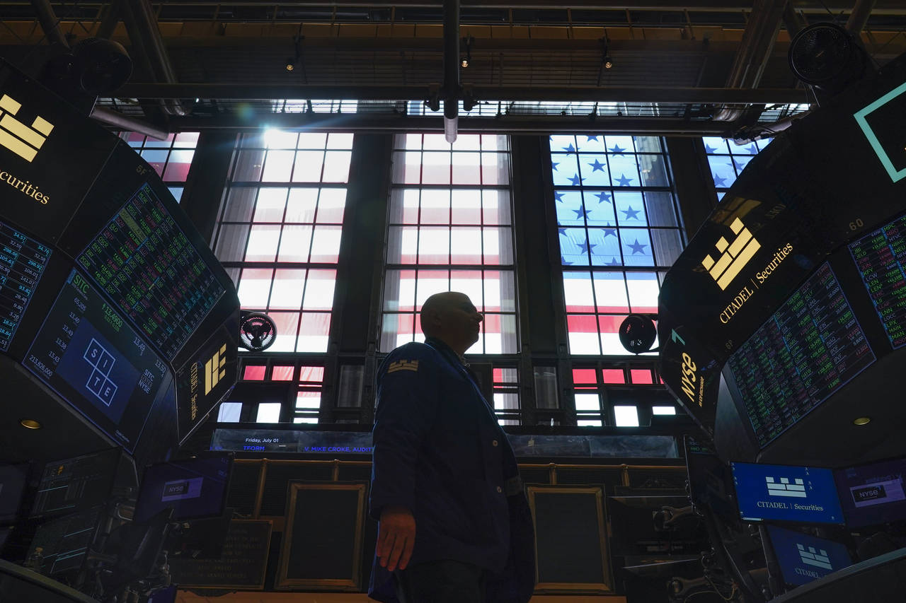 FILE - Traders work on the floor at the New York Stock Exchange in New York, July 1, 2022. Stocks a...