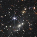 
              This image provided by NASA on Monday, July 11, 2022, shows galaxy cluster SMACS 0723, captured by the James Webb Space Telescope. The telescope is designed to peer back so far that scientists can get a glimpse of the dawn of the universe about 13.7 billion years ago and zoom in on closer cosmic objects, even our own solar system, with sharper focus. (NASA/ESA/CSA/STScI via AP)
            