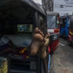 
              A driver of an autorickshaw sleeps inside his rickshaw while waiting in a queue to buy petrol at a fuel station in Colombo, Sri Lanka, Tuesday, July 12, 2022. A political vacuum continues in Sri Lanka with opposition leaders yet to agree on who should replace its roundly rejected leaders, whose residences are occupied by protesters angry over the country’s deep economic woes. (AP Photo/Rafiq Maqbool)
            