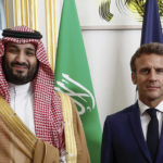 
              French President Emmanuel Macron welcomes Saudi Crown Prince Mohammed bin Salman for a dinner inside the Elysee Palace in Paris, Thursday July 28, 2022. (Benoit Tessier/Pool via AP)
            