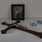 
              A wooden crucifix and a picture of Saint Therese of the Child Jesus and the Holy Face lie on a table inside the Dormition of the Virgin Mary Catholic Church on the Greek island of Santorini on Wednesday, June 15, 2022. The church's bell tower is a destination for tourists who flock to the island, but few are aware that a nearby monastery is home to cloistered nuns who for more than four centuries have lived in seclusion and prayer. (AP Photo/Petros Giannakouris)
            