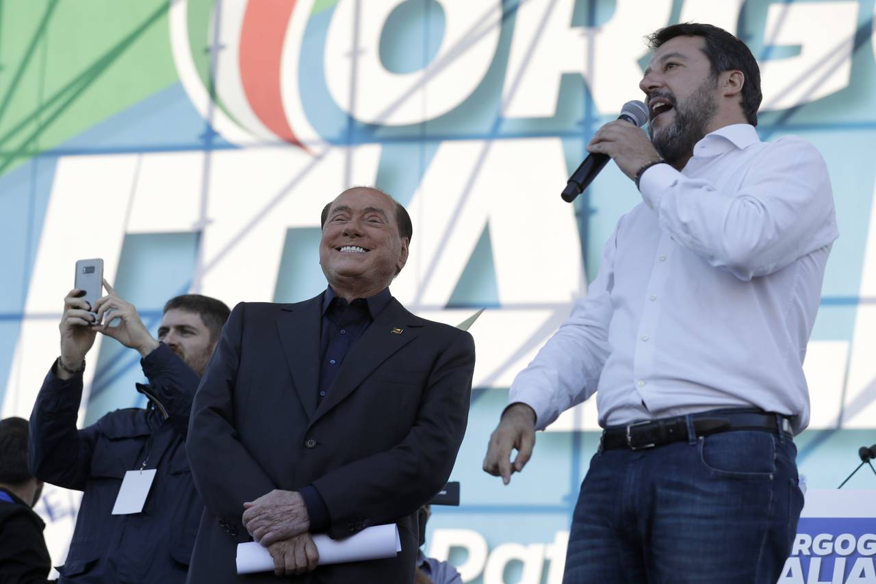 FILE - The League leader Matteo Salvini, right, is flanked by Silvio Berlusconi as he addresses a r...