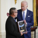 
              President Joe Biden presents the Medal of Honor to Staff Sgt. Edward Kaneshiro for his actions on Dec. 1, 1966, during the Vietnam War, as his son John Kaneshiro accepts the posthumous recognition during a ceremony in the East Room of the White House, Tuesday, July 5, 2022, in Washington. (AP Photo/Evan Vucci)
            