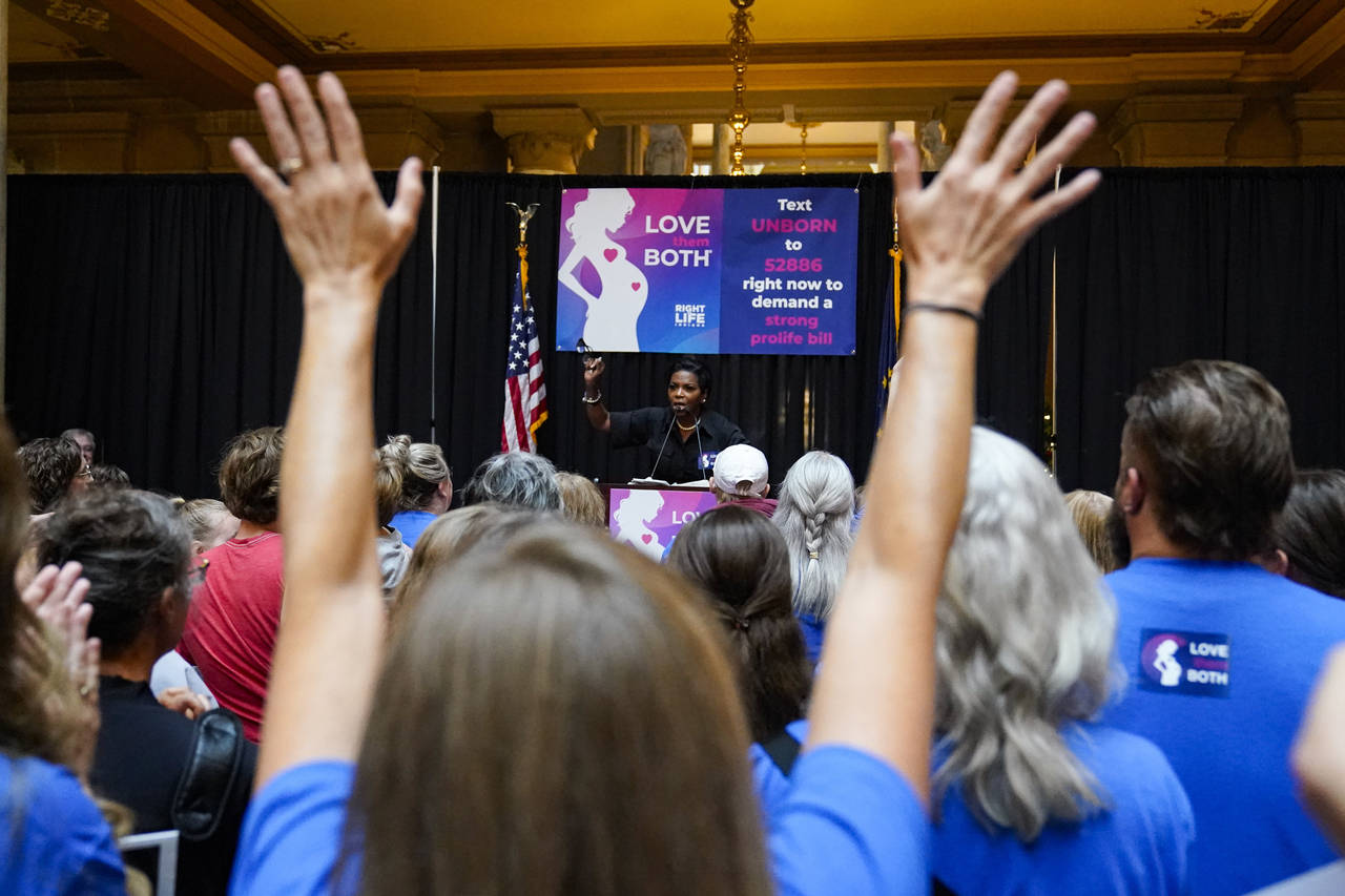 Anti-abortion supporters react as Angela Minter, president of Sisters for Life, speaks at a rally a...