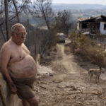 
              Jordi Villalta, 62, stands next to his house burnt during a wildfire in River Park village, near the town of El Pont de Vilomara, Spain, Tuesday, July 19, 2022. Hundreds of residents evacuated by a wildfire in Bages, in northeastern Spain were anxious to get back to their homes and assess the extent of the damage. Jordi could not even salvage his clothes before escaping the flames, "all I have is what I'm wearing, I've lost everything" Jordi said. (AP Photo/Emilio Morenatti)
            
