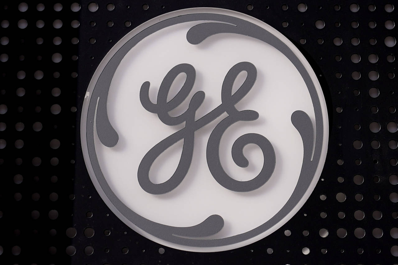 FILE - The General Electric logo is displayed on a sign outside their headquarters, Nov. 10, 2021, ...