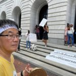 
              Kapsong Kim, an American citizen from New York, holds a Korean percussion instrument as he and others demonstrate outside the 5th U.S. Circuit Court of Appeals in New Orleans on Wednesday, July 6, 2022. A panel of 5th Circuit judges heard arguments on an Obama-era program that prevents the deportation of thousands of immigrants brought into the United States as children. A federal judge in Texas last year declared the Deferred Action for Childhood Arrivals program illegal — although he agreed to leave the program intact for those already benefiting from it while his order is appeal. (AP Photo/Kevin McGill)
            