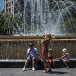 
              A family apply sunscreen to protect themselves from the sun on a hot and sunny day in Barcelona, Spain, Friday, July 15, 2022. (AP Photo/Emilio Morenatti)
            