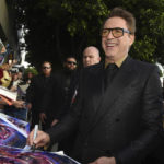 
              FILE - Robert Downey Jr. signs autographs as he arrives at the premiere of "Avengers: Endgame" at the Los Angeles Convention Center, April 22, 2019. The Energy Department is teaming with actor Robert Downey Jr. to recruit up to 1,000 new workers focused on climate change and clean energy. Energy Secretary Jennifer Granholm on Wednesday, July 6, 2022, released a video with the “Iron Man” actor encouraging applicants from diverse backgrounds to join the department's “clean energy corps” and take on jobs aimed at accelerating deployment of clean energy such as wind and solar power. (Photo by Chris Pizzello/Invision/AP, File)
            