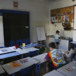 
              Ukrainian refugee children sit in classroom at the Lauder Morasha Jewish school in Warsaw, Poland, Thursday, July 28, 2022. A special summer camp run by Jewish organizations has brought Jewish volunteers from the former Soviet Union to Warsaw to help Ukrainian children. The camp, which ran for most of July and ended Friday, was organized to bring some joy to traumatized children, help prepare them for the school year ahead in Polish schools and give their mothers some time to themselves. (AP Photo/Michal Dyjuk)
            