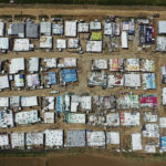 
              FILE - An aerial view shows an informal Syrian refugee camp, in the Bekaa valley town of Saadnayel, east Lebanon, April 23, 2019. Issam Charafeddine, the caretaker Minister for the Displaced, told The Associated Press in an interview Wednesday, July 6, 2022, that Lebanon hopes to start repatriating Syrian refugees within months over objections by the United Nations and rights groups. Lebanon has one of the world's highest numbers of refugees per capita, and currently hosts over 1 million Syrians who fled the decade-old conflict. (AP Photo/Hussein Malla, File)
            