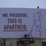 
              A billboard saying "Mr. President, this is apartheid" is posted by an Israeli human rights group in the West Bank town of Bethlehem ahead of the arrival of President Joe Biden in the region, Wednesday, July 13, 2022. The group B'Tselem put up the billboards in Ramallah, the seat of the internationally recognized Palestinian Authority, and in Bethlehem, where Biden is to meet Palestinian President Mahmoud Abbas on Friday. (AP Photo/Mahmoud Illean)
            