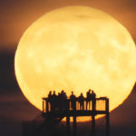 
              People watch the moon rise from the observation tower in Syke, Germany, Wednesday, July 13, 2022. At the same time, the moon is close to the earth, which is why it is called a supermoon. (Thomas Lindemann/dpa via AP)
            