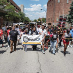
              People walk in an NAACP-led march and rally for Jayland Walker, Sunday, July 3, 2022, in Akron, Ohio. Walker was unarmed when Akron police chased him on foot and killed him in a hail of bullets, but officers believed he had shot at them earlier from a vehicle and feared he was preparing to fire again, authorities said. (Andrew Dolph/Times Reporter via AP)
            