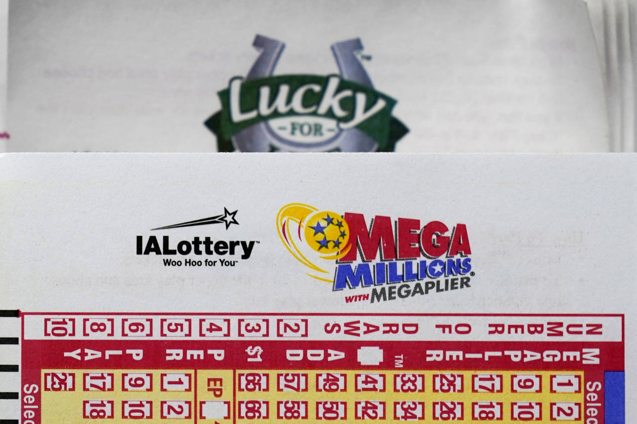 FILE - A Mega Millions lottery play slip is seen in a local grocery store, Monday, July 25, 2022, i...