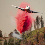 
              An air tanker drops retardant while trying to stop the Oak Fire from reaching the Lushmeadows community in Mariposa County, Calif., on Sunday, July 24, 2022. (AP Photo/Noah Berger)
            