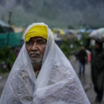 
              Hindu pilgrims return back after a cloudburst at Baltal, 105 kilometers (65miles) northeast of Srinagar, Indian controlled Kashmir, Saturday, July 9, 2022. More than ten pilgrims have been killed and many feared missing after a cloudburst triggered a flash flooding during an annual Hindu pilgrimage to an icy Himalayan cave in Indian-controlled Kashmir. Officials say the cloudburst near the hollowed mountain cave revered by Hindus on Friday sent a wall of water down a mountain gorge and swept about two dozen encampments and two makeshift kitchens. (AP Photo/Mukhtar Khan)
            