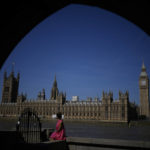 
              A woman poses for her own phone picture framed by an underpass arch on the south bank of the River Thames backdropped by the Elizabeth Tower, known as Big Ben, and the Houses of Parliament, in London, Monday, July 11, 2022. Candidates to replace Boris Johnson as Britain's prime minister are scattering tax-cutting promises to their Conservative Party electorate, as party officials prepare Monday to quickly narrow the crowded field of more than ten candidates. (AP Photo/Matt Dunham)
            