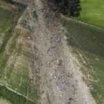 
              This drone photo shows the site where the AN-12 cargo plane crashed, in Palaiochori village near the town of Kavala, in northern Greece, Sunday, July 17, 2022. Experts are poised to investigate the site of a plane crash in northern Greece to determine whether any dangerous chemicals or explosive cargo remains. (AP Photo/Giannis Papanikos)
            