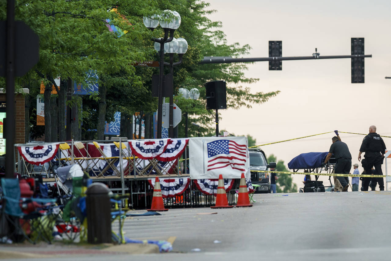 A body is transported from the scene of a mass shooting during the July 4th holiday weekend Monday ...