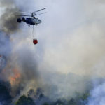 
              A helicopter launches water as a wildfire advances near a residential area in Alhaurin de la Torre, Malaga, Spain, Saturday, July 16, 2022. Wildfires continue to spread across Spain as firefighters work to bring them under control. (AP Photo/Gregorio Marrero)
            