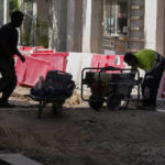 
              Workers repair a street during hot weather in Madrid, Spain, Wednesday, July 20, 2022. (AP Photo/Paul White)
            