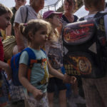 
              Internally displaced people board a train heading to Dnipro, at the Pokrovsk train station, Donetsk region, eastern Ukraine, Friday, July 8, 2022. (AP Photo/Nariman El-Mofty)
            