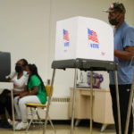 
              People cast their votes at Edmondson Westside High School during Maryland's primary election, Tuesday, July 19, 2022, in Baltimore. (AP Photo/Julio Cortez)
            