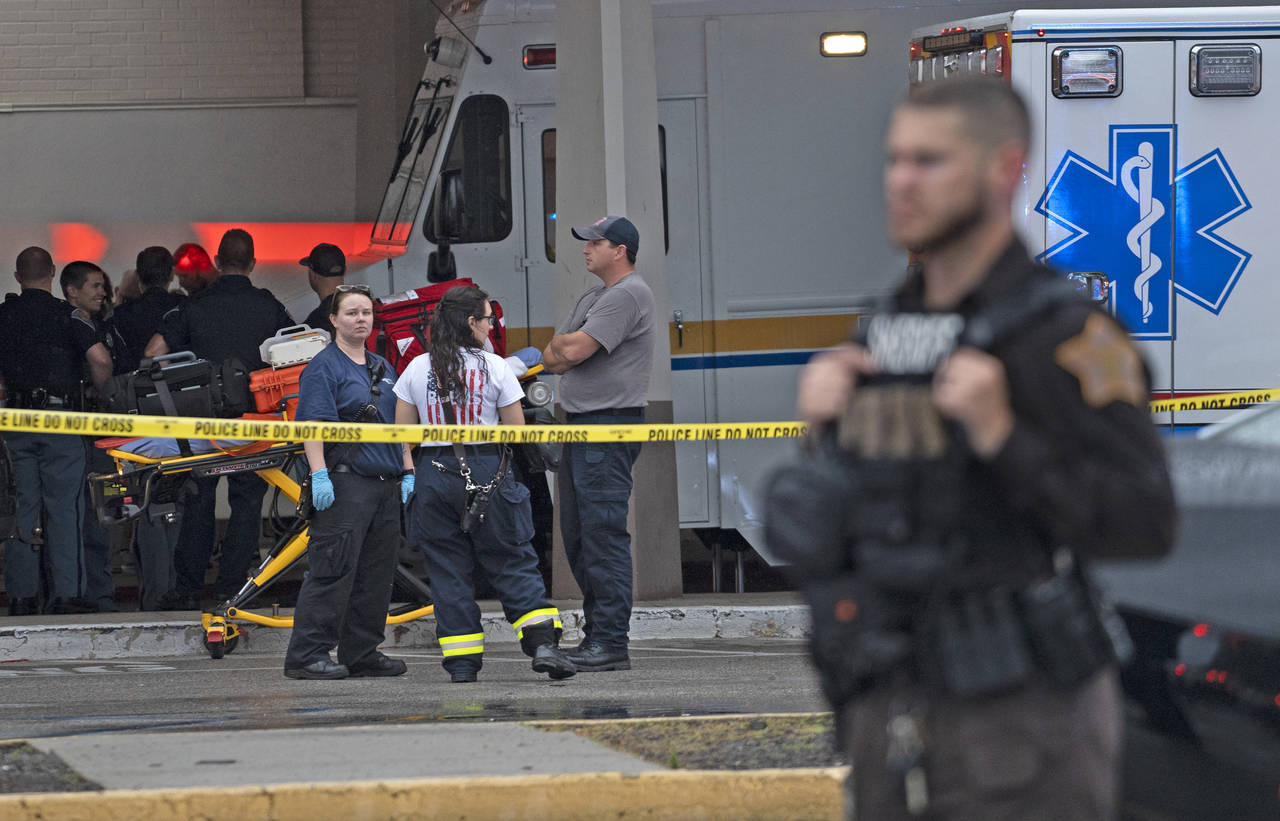 Emergency personnel gather after a deadly shooting Sunday, July 17, 2022, at the Greenwood Park Mal...