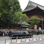 
              The vehicle carrying the body of former Japanese Prime Minister Shinzo Abe leaves Zojoji temple after his funeral in Tokyo on Tuesday, July 12, 2022. Abe was assassinated Friday while campaigning in Nara, western Japan. (AP Photo/Hiro Komae)
            