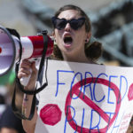 
              Kayce Kean and other abortion rights demonstrators protest outside the Indiana Statehouse during the ongoing special session Friday, July 29, 2022, in Indianapolis. (Jenna Watson/The Indianapolis Star via AP)
            