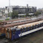 
              Burned-out wagons stand on tracks at the station in Mariupol, in an area controlled by Russian-backed separatist forces, eastern Ukraine, Monday, July 11, 2022. (AP Photo)
            