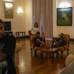 
              Protesters sit on sofa inside the official residence of president Gotabaya Rajapaksa fourth days after it was stormed by anti government protesters in Colombo in Colombo, Sri Lanka, Wednesday, July 13, 2022. The president of Sri Lanka fled the country early Wednesday, days after protesters stormed his home and office and the official residence of his prime minister amid a monthslong economic crisis that triggered severe shortages of food and fuel.(AP Photo/Rafiq Maqbool)
            