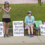 
              Abortion rights supporter Elli Morris, left, played her bamboo flute outside the Jackson Women's Health Organization clinic in Jackson, Miss., as she and others carried signs expressing their opinions, Saturday, July 2, 2022. The clinic is the only facility that performs abortions in the state. On June 24, the U.S. Supreme Court overturned Roe v. Wade, ending constitutional protections for abortion. However, a Mississippi judge has set a hearing for Tuesday, in a lawsuit by the state's only abortion clinic that seeks to block a law that would ban most abortions. (AP Photo/Rogelio V. Solis)
            