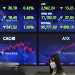 
              A currency trader walks near the screens at a foreign exchange dealing room in Seoul, South Korea, Wednesday, July 27, 2022. Asian stock markets followed Wall Street lower Wednesday as traders prepared for a possible sharp interest rate hike from the Federal Reserve to cool inflation. (AP Photo/Lee Jin-man)
            