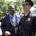
              Michael Cox, left, who has been named as the next Boston police commissioner, stands with Boston police supt. in chief Gregory Long, right, who has served as acting commissioner, Wednesday, July 13, 2022, in Boston's Roxbury neighborhood. Cox, who was beaten more than 25 years ago by colleagues who mistook him for a suspect in a fatal shooting, served in multiple roles with the Boston Police Department before becoming the police chief in Ann Arbor, Michigan, in 2019. (AP Photo/Steven Senne)
            
