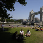 
              People sit and lie in the sun and shade backdropped by Tower Bridge, during hot weather in London, Monday, July 18, 2022. Britain's first-ever extreme heat warning is in effect for large parts of England as hot, dry weather that has scorched mainland Europe for the past week moves north, disrupting travel, health care and schools. (AP Photo/Matt Dunham)
            