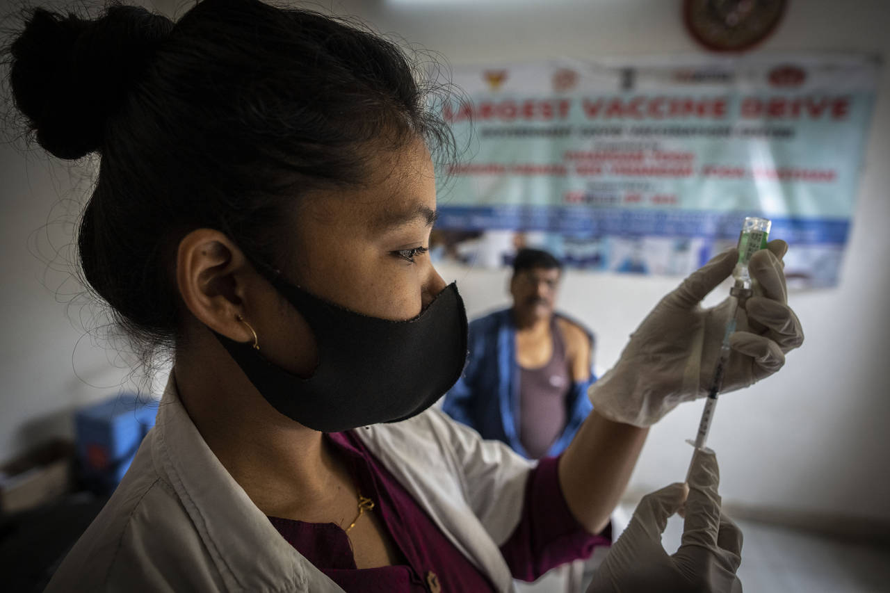 FILE- A nurse prepares to administer vaccine for COVID-19 at a private vaccination center in Gauhat...