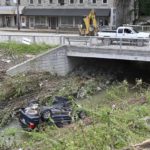 
              A car lays overturned in Troublesome Creek in downtown Hindman, Ky., Sunday, July 31, 2022. (AP Photo/Timothy D. Easley)
            