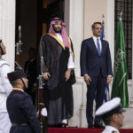 
              Greek Prime Minister Kyriakos Mitsotakis, right, and Saudi Crown Prince Mohammed bin Salman listen to the Greek national anthem prior to their meeting in Athens, Tuesday, July 26, 2022. Bin Salman arrived in Greece Tuesday on his first trip to a European Union country since the killing in 2018 of Saudi journalist Jamal Khashoggi that triggered widespread international condemnation. (AP Photo/Petros Giannakouris)
            