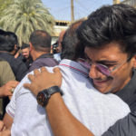 
              Men mourn Abbas Abdul Hussein, a 30-year-old victim of an artillery strike, after his body was received by his family in Baghdad, to later lay him to rest in Najaf city, Thursday, July 21, 2022, in Baghdad, Iraq. Hussein was on his honeymoon, five days after his wedding, when at least four artillery shells struck the resort area of Barakh in the Zakho district in the Iraqi semi-autonomous Kurdish-run region, killing nine people. (AP Photo/Ali Jabar)
            