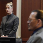 
              FILE - Actors Amber Heard and Johnny Depp watch as the jury leaves the courtroom for a lunch break at the Fairfax County Circuit Courthouse in Fairfax, Va., Monday, May 16, 2022.  Heard notified a Virginia court Thursday, July 21,  that she will appeal the $10.35 million judgment she was ordered to pay Depp during a high-profile defamation trial that exposed the inner workings of their troubled marriage.   (AP Photo/Steve Helber, Pool, File)
            